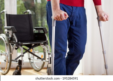 Horizontal View Of A Disabled Man On Crutches