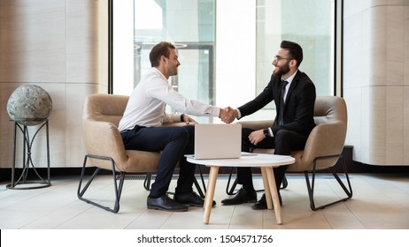 Horizontal view european and arabian businessmen in formal wear accomplish meeting shaking hands feels satisfied after negotiations, HR manager greeting applicant before job interview process concept - Shutterstock ID 1504571756