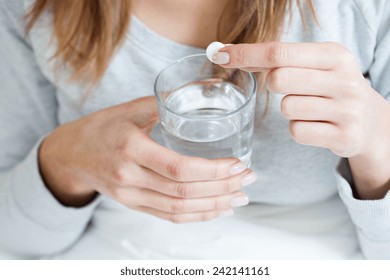 Horizontal View Of Ill Woman Taking Aspirin