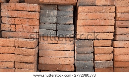 Horizontal view of stacked clay bricks featuring rough surfaces, earthy colors, and natural textures, suitable for construction and design backgrounds
