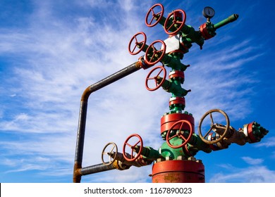 Horizontal view of a wellhead with valve armature. Oil and gas industry concept. Industrial site background. Toned.