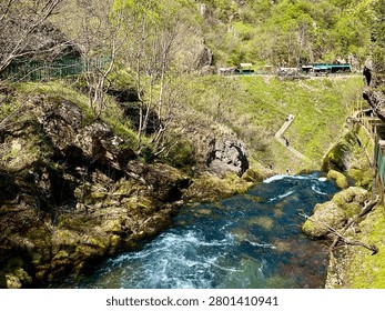 Horizontal view of White Drin River spring flowing through karst landscape near Radavc in Kosovo