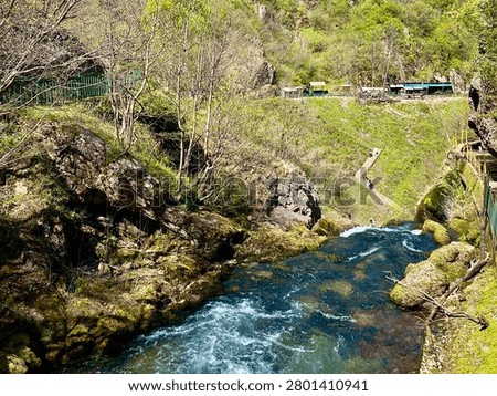 Horizontal view of White Drin River spring flowing through karst landscape near Radavc in Kosovo