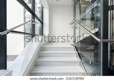 Horizontal view of white stairs in business building