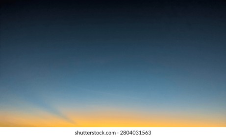 A horizontal wide angle perspective captures a dark dawn morning sky transitioning into a bright orange yellow sunrise gradient on the horizon line. The simple natural landscape layout template creates a beautiful minimalist presentation backdrop with open copy space.