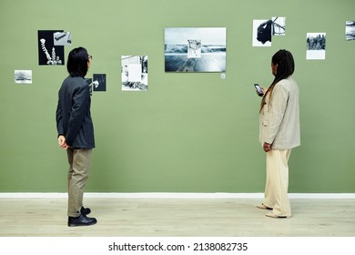 Horizontal Wide Shot Of Young Asian Man And Black Woman Spending Free Time Visiting Modern Black And White Photography Exhibition In Art Gallery