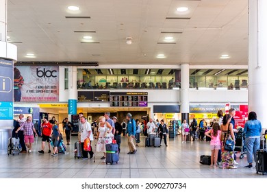 Horley, UK - June 28, 2018: Gatwick London Airport Terminal With People Walking Inside Building Architecture And Arrival Departure Board Sign