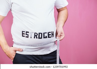 hormonal imbalance, weight gain, estrogen level, hormonal therapy. overweight man belly with measuring tape