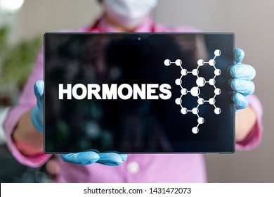 Hormone Health Care Science concept. Doctor or scientist holds tablet computer with hormones structure on display.