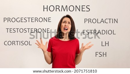 Hormones imbalance. Annoyed mature woman and different words on light background, banner design