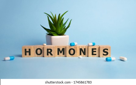 HORMONES word cube on a blue background. Medical concept