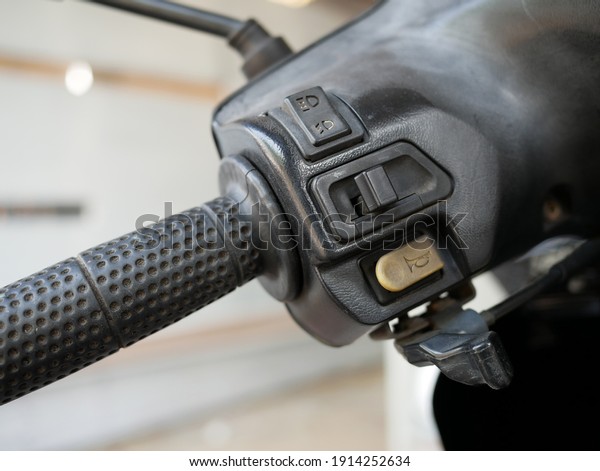 horn\
switch and light switch on a motorcycle\
handlebar.