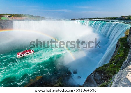 Hornblower Boat Full of Tourists Under Rainbow Sprayed By Horseshoe Waterfall, Niagara Falls, Ontario, Canada