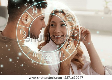 Horoscope compatibility. Loving couple indoors and zodiac wheel