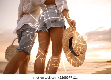 Horoscope compatibility. Loving couple on beach at sunset and zodiac wheel - Powered by Shutterstock