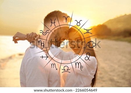 Horoscope compatibility. Loving couple on beach at sunset and zodiac wheel
