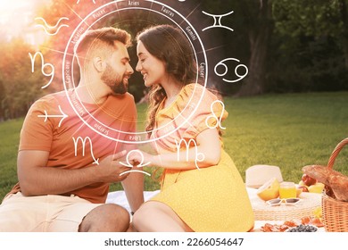 Horoscope compatibility. Loving couple outdoors and zodiac wheel - Powered by Shutterstock