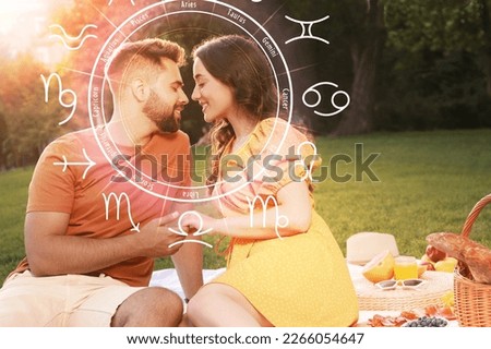 Horoscope compatibility. Loving couple outdoors and zodiac wheel