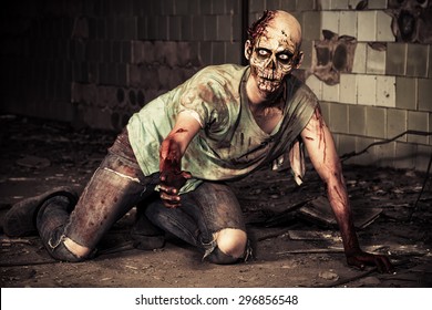 Horrible scary zombie man on the ruins of an old house. Horror. Halloween. 