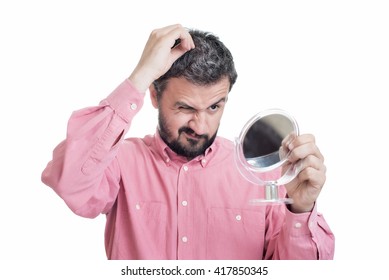 Horrified Young Man Looking In The Mirror At The First Grey Hair On His Scalp