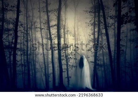 Horror background of a ghostly figure in enchanted a forest on a moody, foggy night. Halloween concept