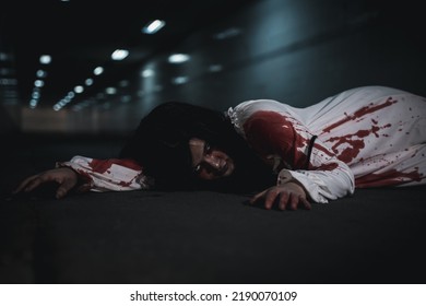 Horror Bloodthirsty Woman Ghost Horror She Death And Scary At Dark Night In Tunnel, The Girl Was Hit By A Car And Lying Died On The Road. Full Of Blood Left Unattended, Happy Halloween Day Festival