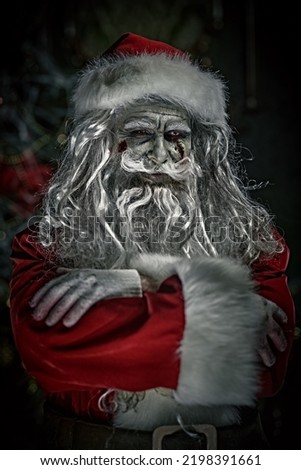 Horror Christmas and New Year.  Scary old man zombie Santa Claus smiles evilly while standing in a dark Christmas room. Halloween.