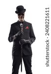 Horror elegant Halloween character with skull head posing and looking at camera, he is wearing a suit and bowler hat