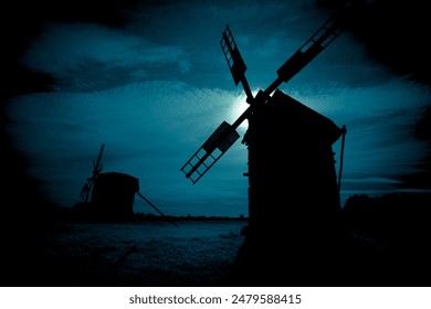 Horror fairytale night landscape with an old rustic windmill silhouette under the full moon. Halloween background. - Powered by Shutterstock