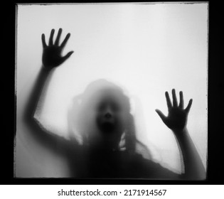 Horror ghost girl behind the matte glass in black and white. Halloween festival concept. - Shutterstock ID 2171914567
