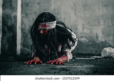 Horror ghost woman crawling with resentment  torture and ask for help, with blood in hand. Halloween murder concept.