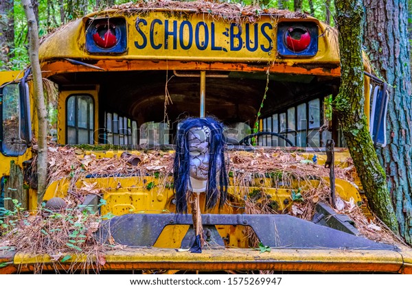 Horror Mask on School\
Bus in a Junkyard