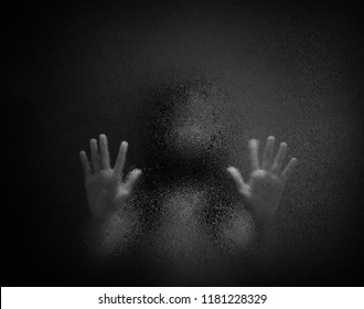 Horror Scary Shadow Of Woman Behind  Glass In Black And White. Blurred Of  Ghost Or Dead People In Darkness. Stressed Girl Trapped In The Room, Concept Of Halloween Or Violence Against Children.