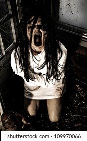 Horror Scene Of A Woman Possessed Wearing A Straight Jacket Screaming