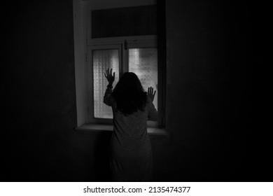Horror Silhouette Inside Abandoned Creepy Room With Window At Night. Horror Scene. Halloween Concept.