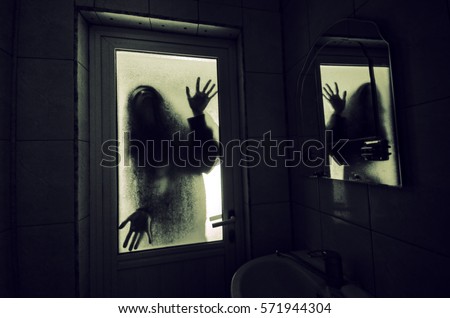 Horror woman in window wood hand hold cage scary scene halloween concept Blurred silhouette of witch