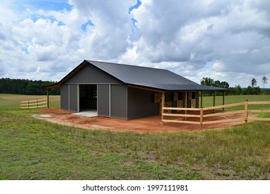 Horse barn built with post frame materials; two lean-to's, two sliding barn doors, six stalls, concrete floor - Shutterstock ID 1997111981