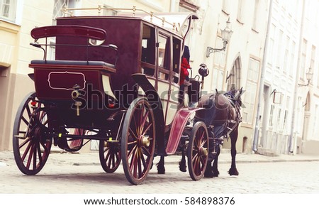 Horse and a beautiful old carriage in old town. 