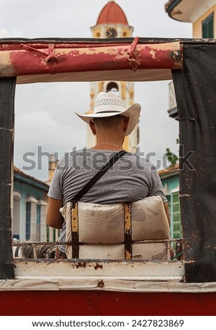 Horse - draw carriage coachman waiting for foreign clients in the Plaza Mayor of Trinidad - Cuba. 