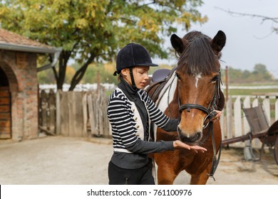 A horse eats from a girl's hand- Young girl feeds her horse out of her hand - Powered by Shutterstock