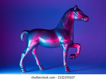 Horse Figurine With Neon Blue And Pink Illumination Background. Future Warfare Conceptual Backdrop.