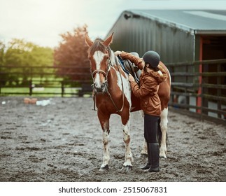 Horse, girl and adjust saddle at farm for race, sport and training at countryside ranch. Animal, equestrian and prepare seat for riding with pet for safety, care and protection with teenager outdoor - Powered by Shutterstock