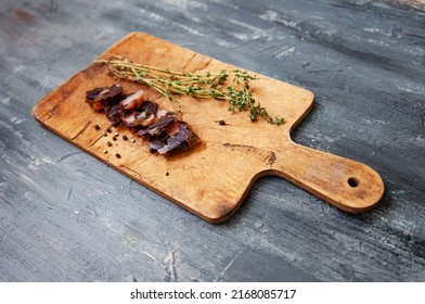 Horse meat and fat middle asian tatar cuisine sausage
Sliced dark fillet on rustic wood board