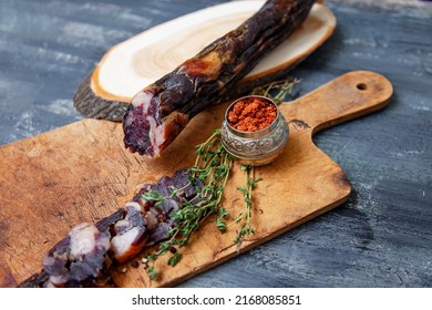 Horse meat and fat middle asian tatar cuisine sausage
Sliced dark fillet on rustic wood board