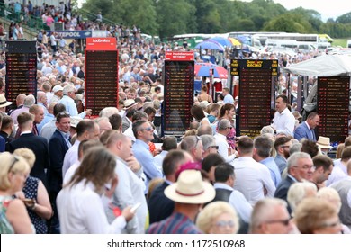 HORSE RACING - Bookmakers Stands And Boards Are Visible Above The Milling Crowds At Thirsk Races : Thirsk Racecourse, Nth Yorkshire, UK : 4 August 2018 : Pic Mick Atkins