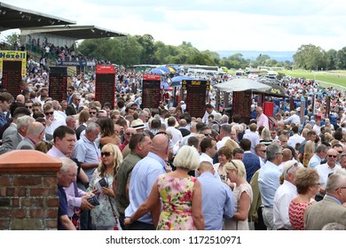 HORSE RACING - Bookmakers Stands And Boards Are Visible Above The Milling Crowds At Thirsk Races : Thirsk Racecourse, Nth Yorkshire, UK : 4 August 2018 : Pic Mick Atkins