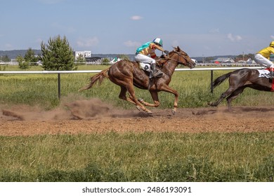 Horse racing at the racetrack. A horse led by a jockey. Horse riding competitions. A rider on a horse. Horses gallop along the racetrack track. - Powered by Shutterstock