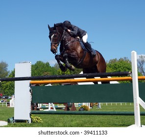 A horse and rider over a jump