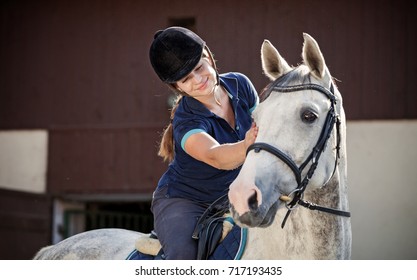 Horse rider woman near stable, horsewoman before training - Powered by Shutterstock