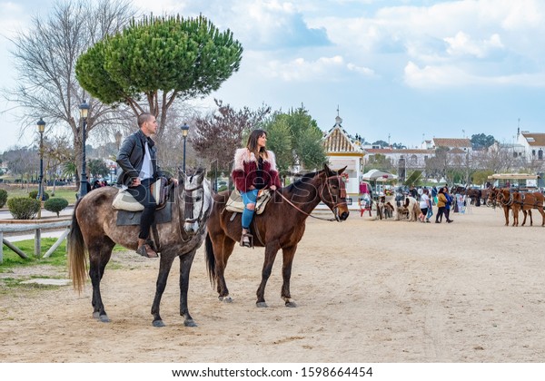 Horse riders, El Rocio, Spain -\
February 24, 2018: western themed town in Southern Spain\
\

